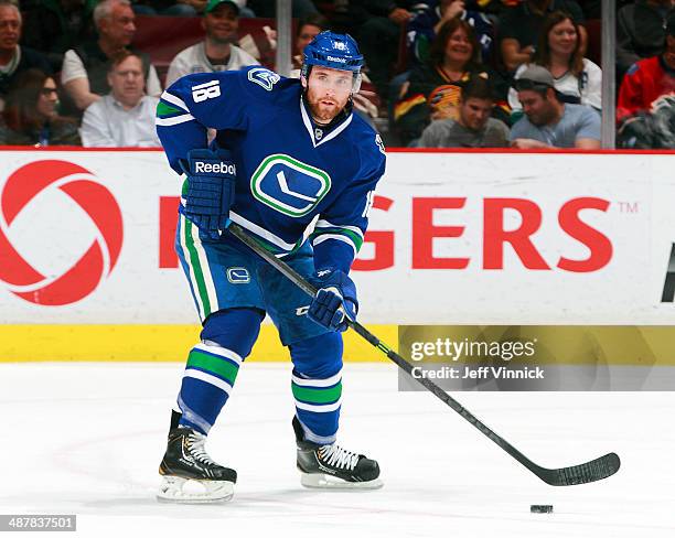 Ryan Stanton of the Vancouver Canucks skates up ice with the puck during their NHL game against the Calgary Flames at Rogers Arena April 13, 2014 in...