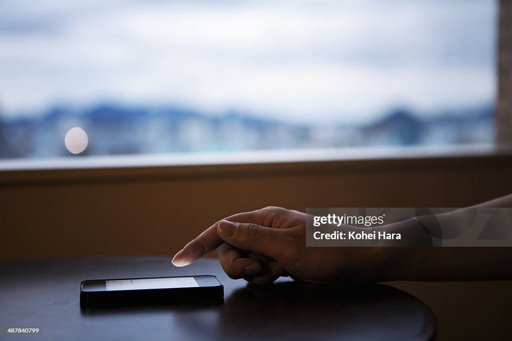 Man's hand using a smart phone