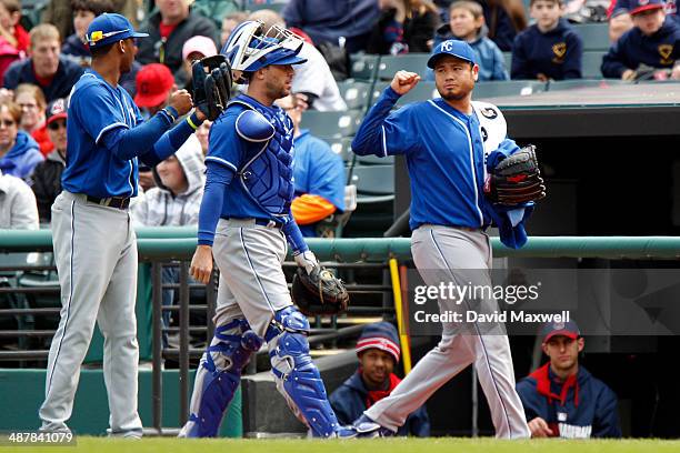 Alcides Escobar, Bruce Chen, and Brett Hayes of the Kansas City Royals walk to the dugout before the start of the game against the Cleveland Indians...