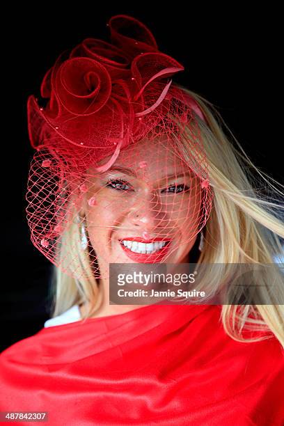 Race fan wearing a festive hat poses prior to the 140th running of the Kentucky Oaks at Churchill Downs on May 2, 2014 in Louisville, Kentucky.