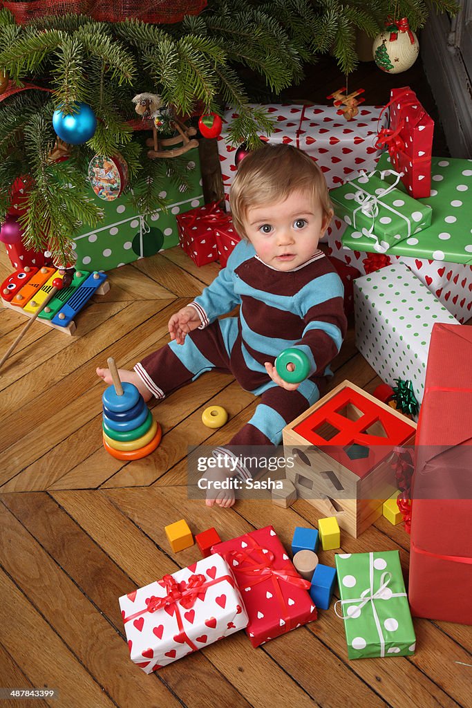 Baby oppening his christmas presents