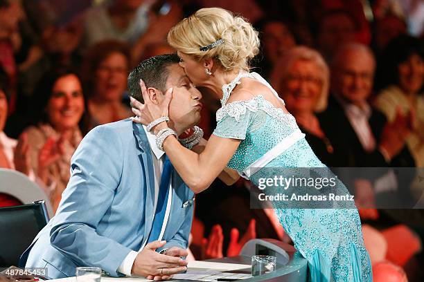 Tanja Szewczenko kisses jury member Joachim Llambi during the 5th show of 'Let's Dance' on RTL at Coloneum on May 2, 2014 in Cologne, Germany.