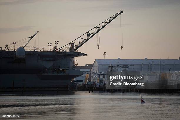 Crane is seen past the USS Enterprise aircraft carrier as it floats pier side during inactivation at Huntington Ingalls Industries' Newport News...