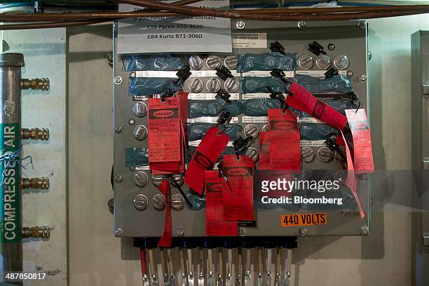 Danger tags hang on a control panel aboard the USS Gerald R. Ford aircraft carrier during outfitting and testing at Huntington Ingalls Industries'...
