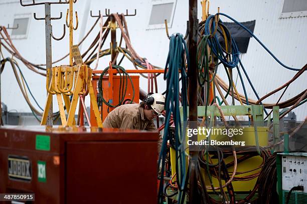 Shipbuilder works near the covered catapult system aboard the USS Gerald R. Ford aircraft carrier during outfitting and testing at Huntington Ingalls...