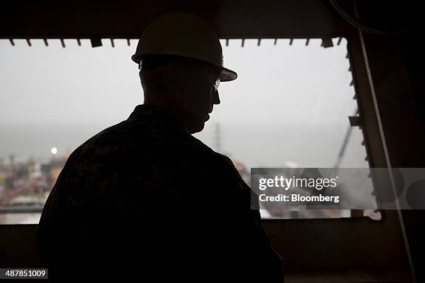 Capt. John Meier, commanding officer of the USS Gerald R. Ford aircraft carrier, stands in the bridge area of the island tower during outfitting and...