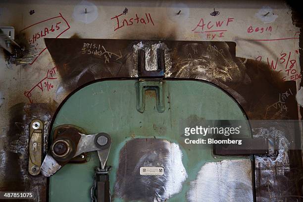Construction markings line a door inside the bridge of the island tower aboard the USS Gerald R. Ford aircraft carrier during outfitting and testing...