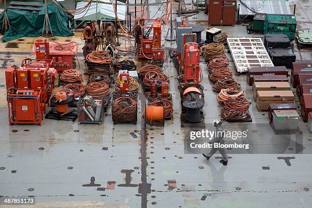 Shipbuilder walks on the deck of the USS Gerald R. Ford aircraft carrier during outfitting and testing at Huntington Ingalls Industries' Newport News...