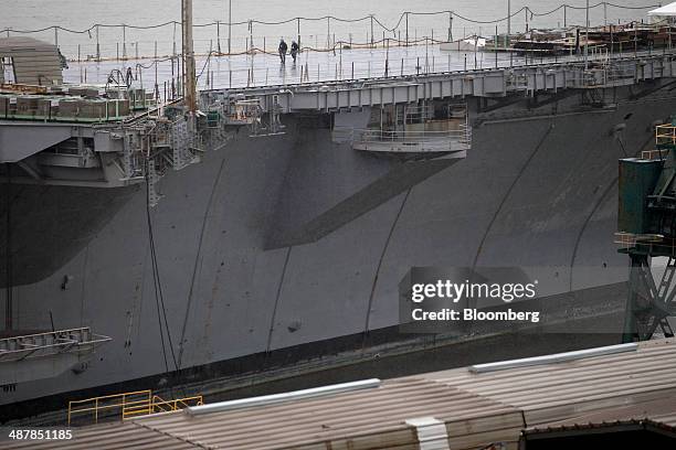 Navy sailors walk on the deck of the USS Enterprise aircraft carrier during inactivation at Huntington Ingalls Industries' Newport News Shipbuilding...