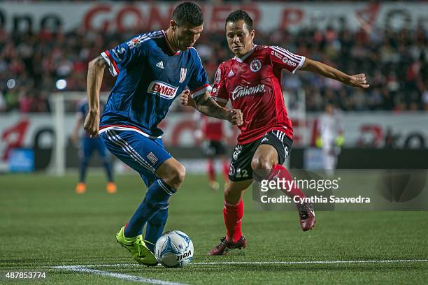 Jorge Enriquez of Chivas and Juan Carlos Nuñez of Tijuana fight for the ball during a 8th round match between Tijuana and Chivas as part of the...