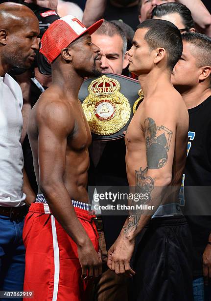 Welterweight champion Floyd Mayweather Jr. And WBA champion Marcos Maidana face off during their official weigh-in at the MGM Grand Garden Arena on...