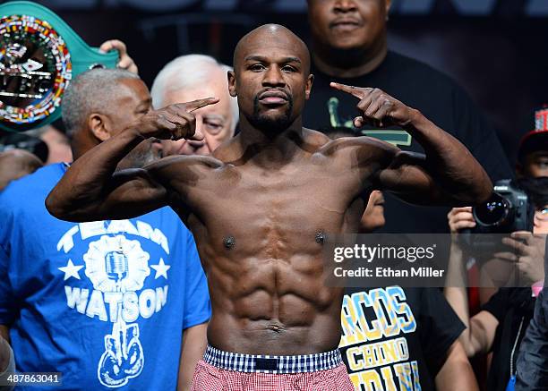 Welterweight champion Floyd Mayweather Jr. Poses on the scale during his official weigh-in at the MGM Grand Garden Arena on May 2, 2014 in Las Vegas,...