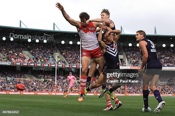 Mike Pyke of the Swans contests a mark against Zac Dawson and Danyle Pearce of the Dockers during the First AFL Qualifying Final match between the...