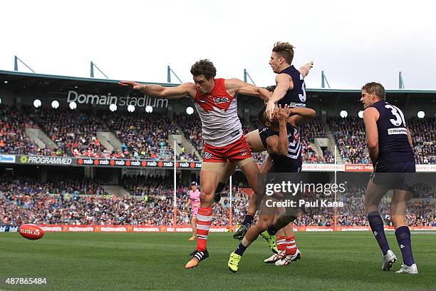 Mike Pyke of the Swans contests a mark against Zac Dawson and Danyle Pearce of the Dockers during the First AFL Qualifying Final match between the...