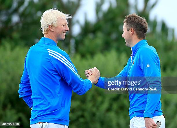 Ashley Chesters and Jimmy Mullen of Great Britain and Ireland celebrate on the 16th green after they had won their match by 3&2 against Maverick...