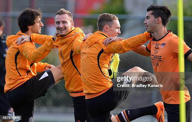 Thomas Broich, Besart Berisha, Matthew Smith and George Lambadaridis share a laugh as they warm up during a Brisbane Roar A-League training session...