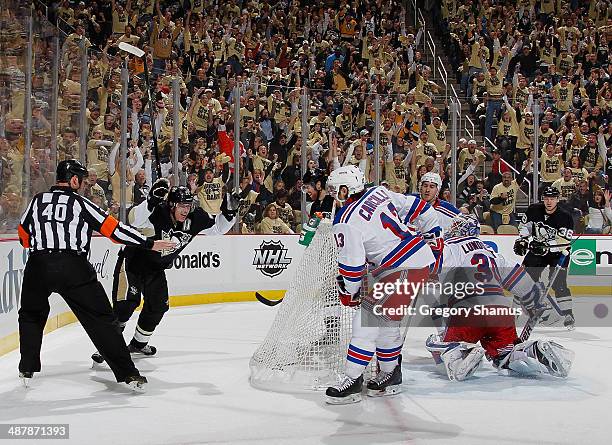 James Neal of the Pittsburgh Penguins celebrates his goal with Evgeni Malkin in front of Daniel Carcillo and Henrik Lundqvist of the New York Rangers...