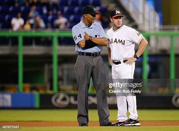 Mike Redmond of the Miami Marlins talks with umpire CB Bucknor during the first inning of the game at Marlins Park on May 02, 2014 in Miami, Florida.