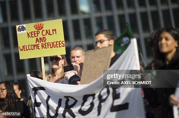 Pro Migration Partcipant of a pro-migrants demonstration holds a sign reading 'Keep ...