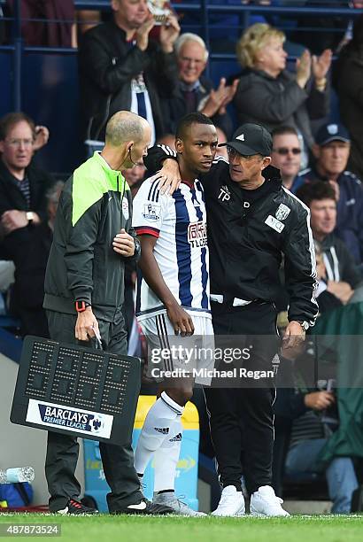 Tony Pulis, manager of West Bromwich Albion talks to Saido Berahino as he comes on as a substitute during the Barclays Premier League match between...