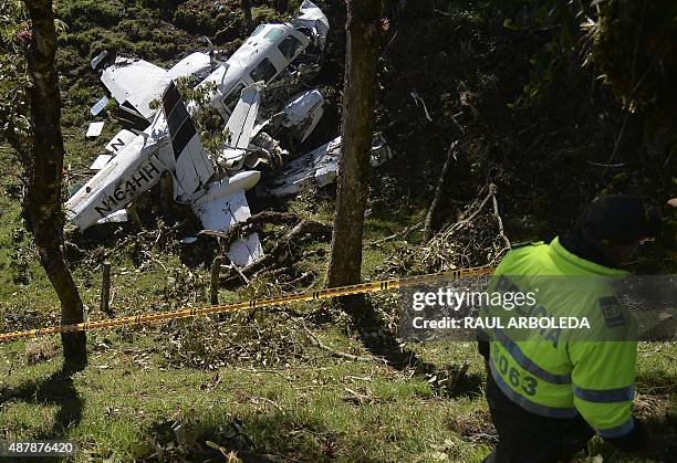 Colombian Police custody the wreckage of a Piper PA-60 Aerostar twin-engine aircraft that crashed on the eve, on September 12, 2015 near San Pedro de...