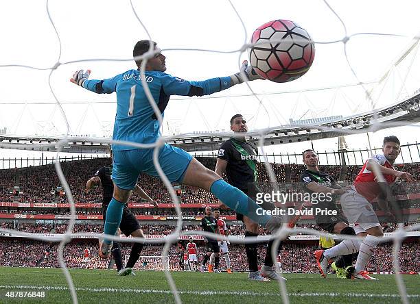 Olivier Giroud scores Arsenal's 2nd goal past Jack Butland of Stoke during the Barclays Premier League match between Arsenal and Stoke City on...