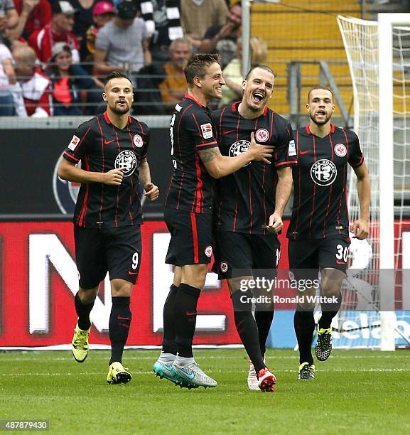 Alexander Meier of Frankfurt celebrates after scoring his team's first goal with his team-mates Bastian Oczipka during the Bundesliga match between...