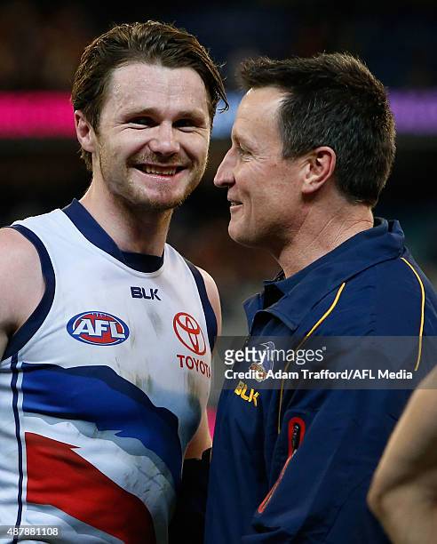 Patrick Dangerfield of the Crows is congratulated by Director of Coaching John Worsfold during the 2015 AFL Second Elimination Final match between...