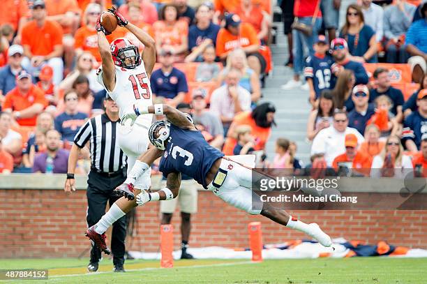 Wide receiver Ruben Gonzalez of the Jacksonville State Gamecocks catches a pass over defensive back Jonathan Jones of the Auburn Tigers on September...