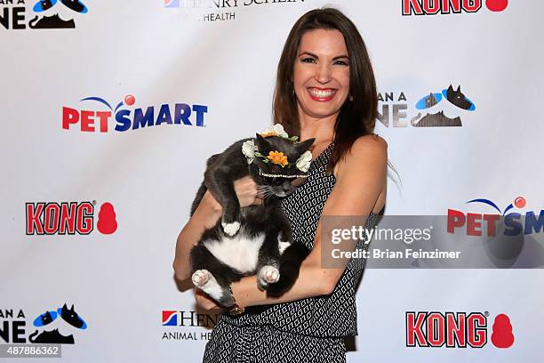 Brean Johnson poses with Bagel, a.k.a. Sunglass Cat, as she attends the 2nd annual More Than A Cone 2015 Art Festival fundraising event at The Autry...