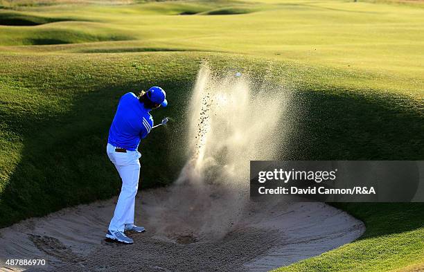 Ewen Ferguson of the Great Britain and Ireland Team plays his second shot from a fairway bunker on the 17th hole in his match against Maverick...