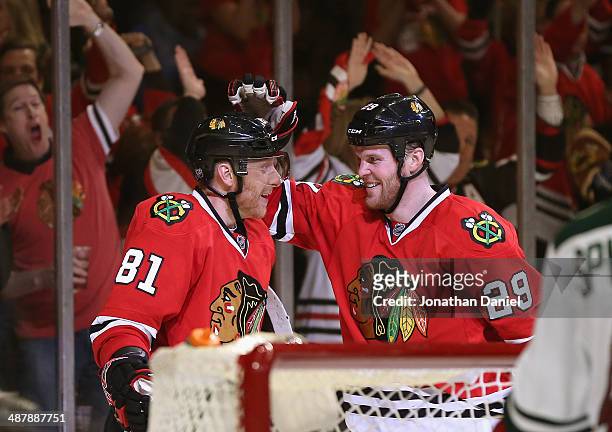 Marian Hossa and Bryan Bickell of the Chicago Blackhawks celebrate Hossa's second period goal against the Minnesota Wild in Game One of the Second...