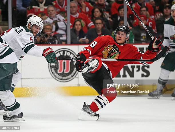 Ben Smith of the Chicago Blackhawks keeps his balance after colliding with Marco Scandella of the Minnesota Wild in Game One of the Second Round of...