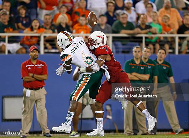Sharrod Neasman of the Florida Atlantic Owls breaks up the pass intended for Herb Waters of the Miami Hurricanes on September 11, 2015 at FAU Stadium...