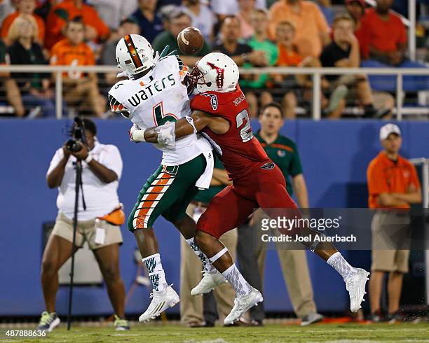 Sharrod Neasman of the Florida Atlantic Owls breaks up the pass intended for Herb Waters of the Miami Hurricanes on September 11, 2015 at FAU Stadium...