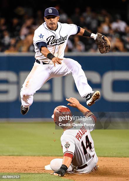 Everth Cabrera of the San Diego Padres jumps over Martin Prado of the Arizona Diamondbacks as he turns a double play during the eighth inning of a...