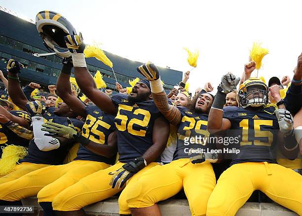 Royce Jenkins-Stone and Ty Isaac of the Michigan Wolverines celebrate a win over the Oregon State Beavers on September 12, 2015 at Michigan Stadium...