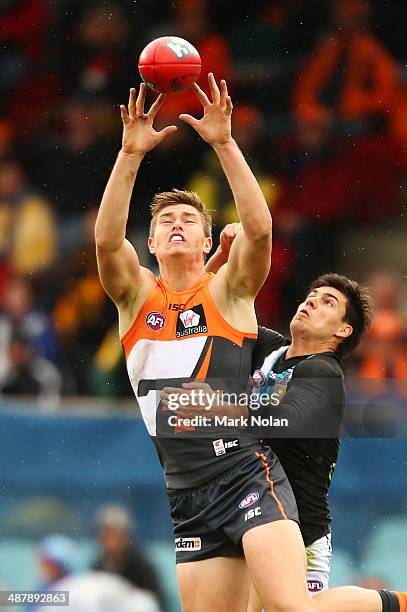 Adam Tomlinson of the Giants and Angus Monfries of the Power contest possession during the round seven AFL match between the Greater Western Sydney...