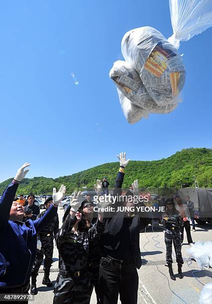 Human rights activist Suzanne Scholte and former North Korean defectors in their uniforms release a balloon carrying anti-Pyongyang leaflets in Paju...