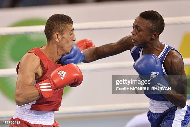Algeria's Mohamed Flissi and Sankuru Nkolomoni of the Democratic Republic of Congo compete in the men's light fly boxing final at the 11th Africa...
