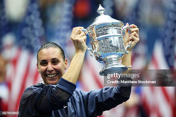 Flavia Pennetta of Italy celebrates with the winner's trophy after defeating Roberta Vinci of Italy during their Women's Singles Final match on Day...