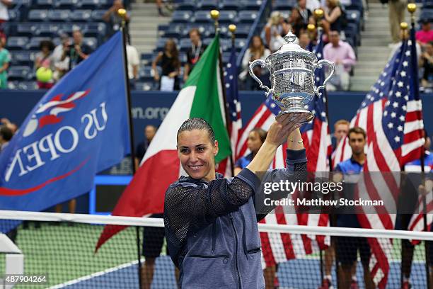 Flavia Pennetta of Italy celebrates with the winner's trophy after defeating Roberta Vinci of Italy during their Women's Singles Final match on Day...