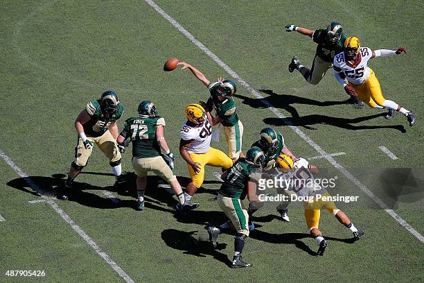Quarterback Nick Stevens of the Colorado State Rams delivers an incomplete pass against the defense of Steven Richardson of the Minnesota Golden...