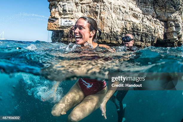 In this handout image provided by Red Bull, Anna Bader of Germany reacts after diving from the 22 metre platform during the first rounds of the...