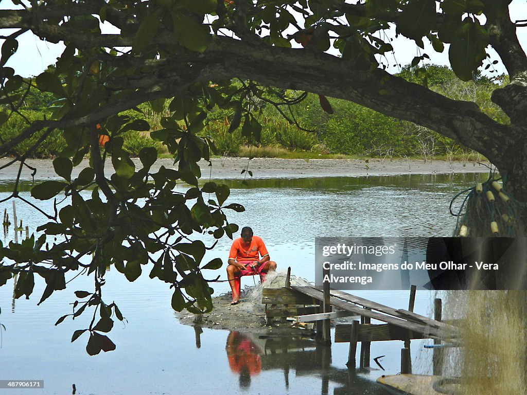 Fisherman repairing net