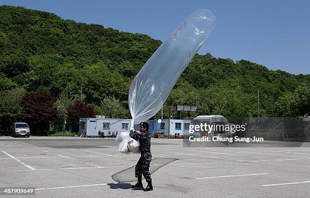 North Korean defector, now living in South Korea, prepares to release balloon carrying propaganda leaflets denouncing North Korea's nuclear test,...