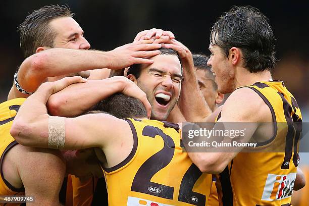 Jordan Lewis of the Hawks is congratulated by team mates after kicking a goal in his 200th match during the round seven AFL match between the...