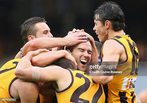 Jordan Lewis of the Hawks is congratulated by team mates after kicking a goal in his 200th match during the round seven AFL match between the...