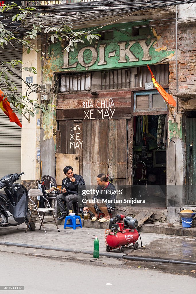 Men outside deprived townhouse