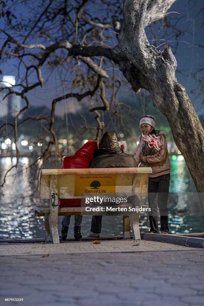 Street vendor selling rose to couple